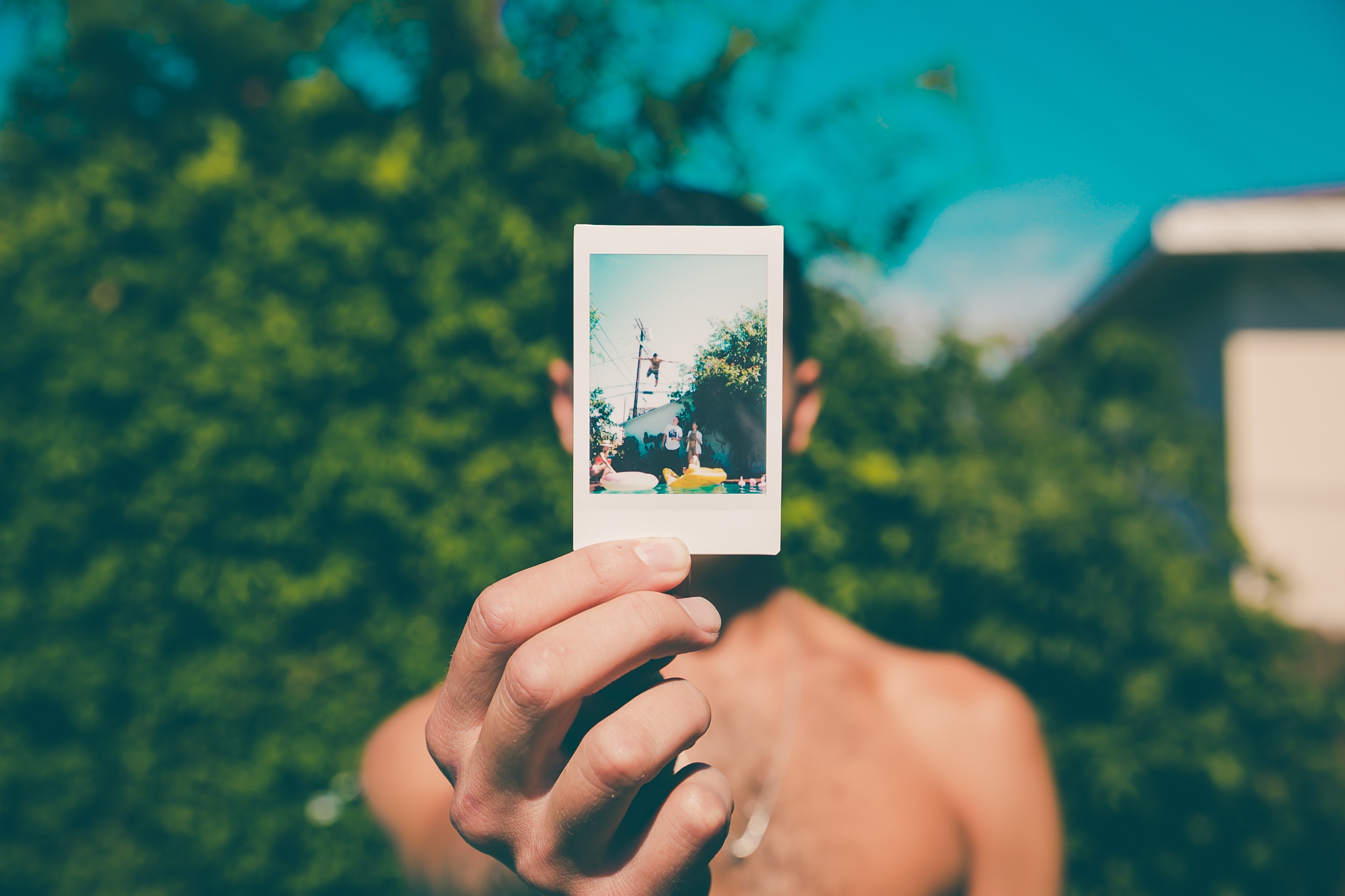 picture of boy holding up a small picture